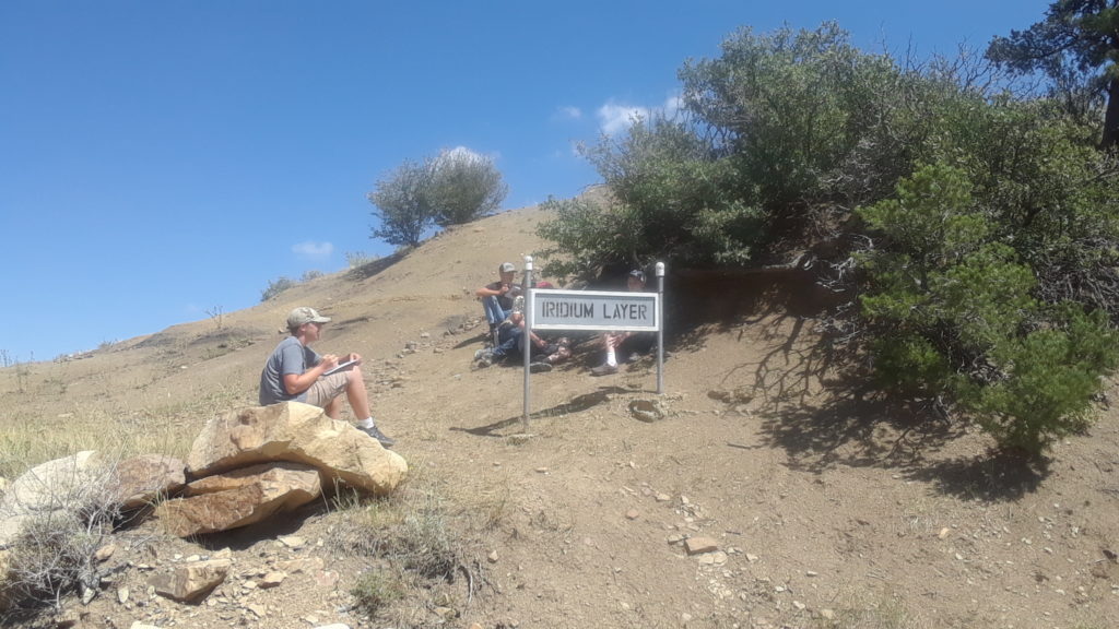 Student at Iridum Layer sign on Goat Hill